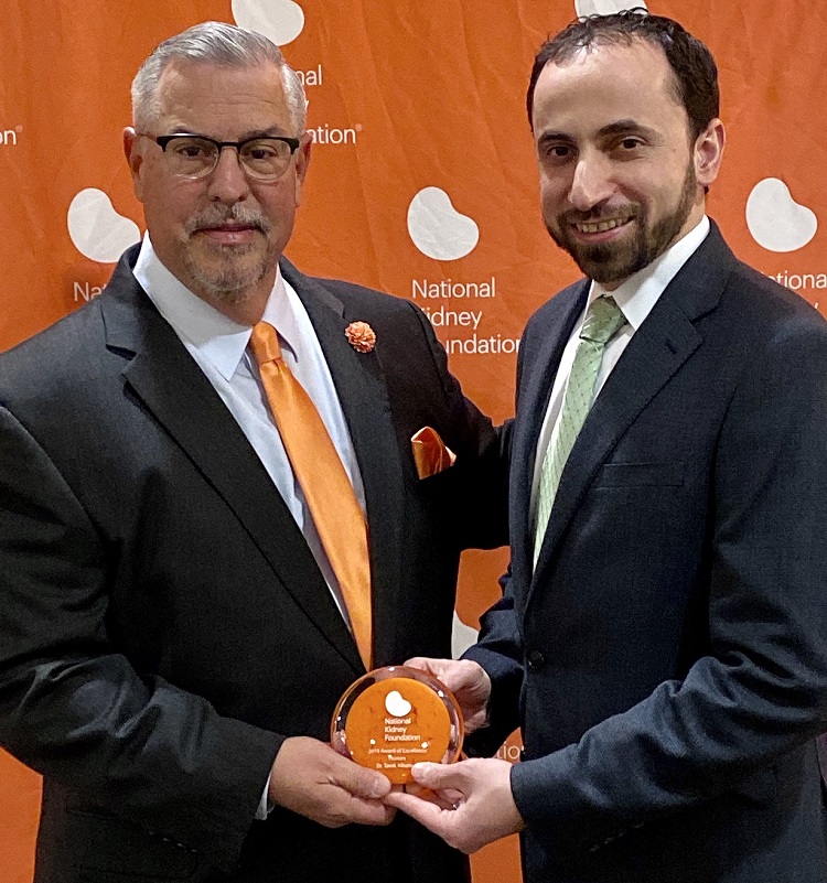 Gene Ridolfi presents Tarek Alhamad with Award of Excellence